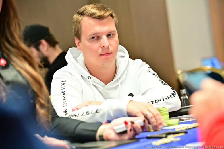 Aleksejs Ponakovs, a professional poker player from Riga, Latvia, sits confidently at a poker table, surrounded by chips and cards. 