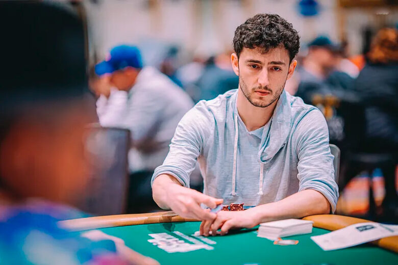 Aleksejs Ponakovs concentrates intently during a high-stakes live poker tournament.