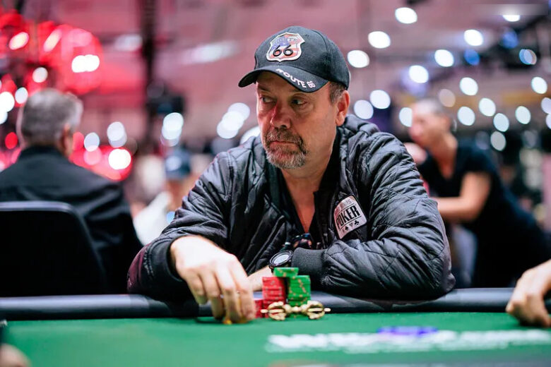 A focused Andy Black, known as "The Monk," sits at a poker table during a high-stakes tournament.