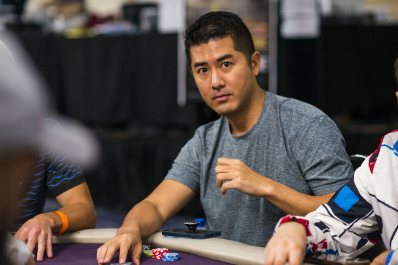 Andy "Andy Stacks" Tsai, focused and poised, plays at a poker table during a high-stakes game.