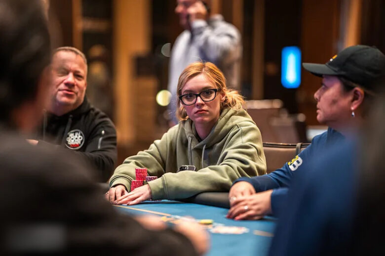 Brittney Stout featured on a leaderboard display at a poker tournament, her name among the top players.