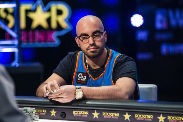 A close-up of Bryn Kenney holding a hand of winning cards with a calm yet focused expression.