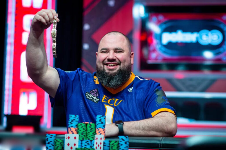 hris Hunichen holding a championship trophy at a prestigious poker event, smiling proudly.